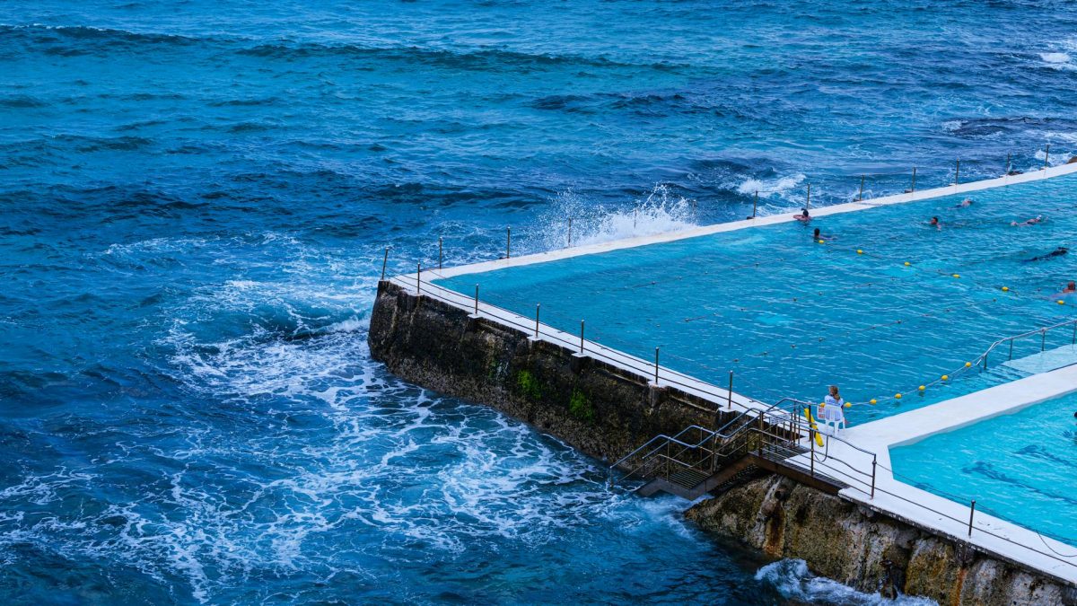 A vibrant capture of Bondi Icebergs Pool with ocean waves crashing nearby, Sydney, Australia.