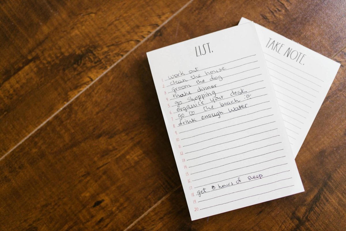 Close-up of a handwritten to-do list on a wooden surface, perfect for organization themes.