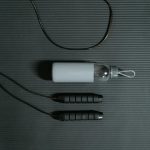 Flat lay of jump rope and water bottle on a yoga mat for fitness and hydration.