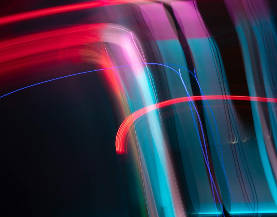 Dynamic and colorful long exposure light streaks in an abstract artistic composition.